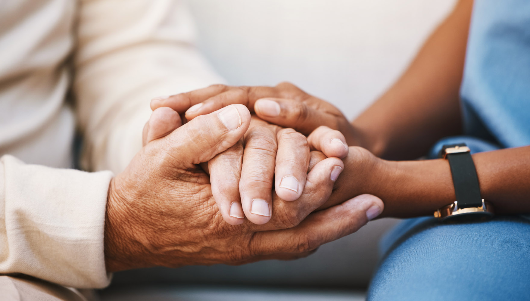 Caring hands supporting elderly person